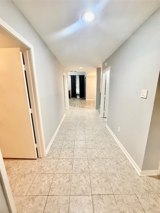 corridor featuring light tile patterned floors