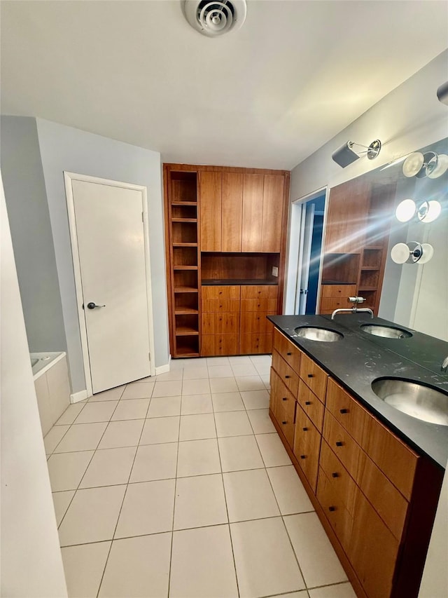 bathroom featuring a bath, tile patterned flooring, and vanity