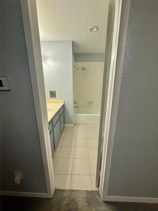 bathroom with vanity, tile patterned floors, and tiled shower / bath combo