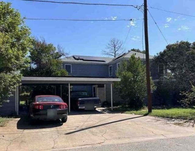 front facade with a carport