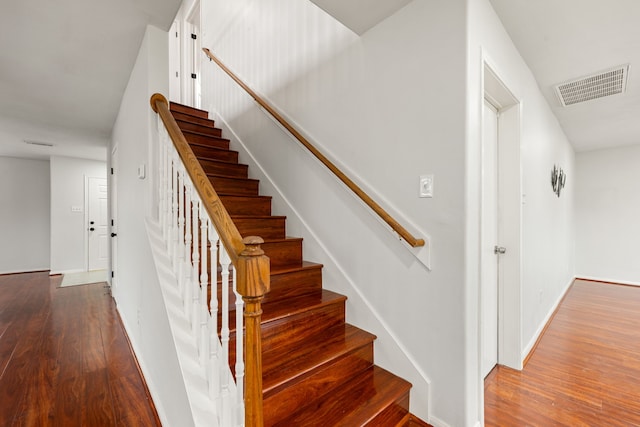 staircase with hardwood / wood-style flooring