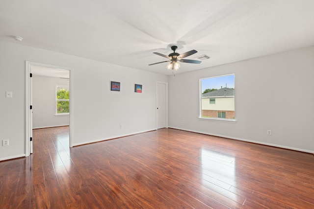 unfurnished room with ceiling fan and dark wood-type flooring