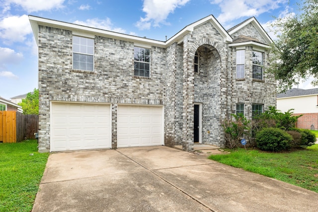 view of front of house with a garage and a front lawn