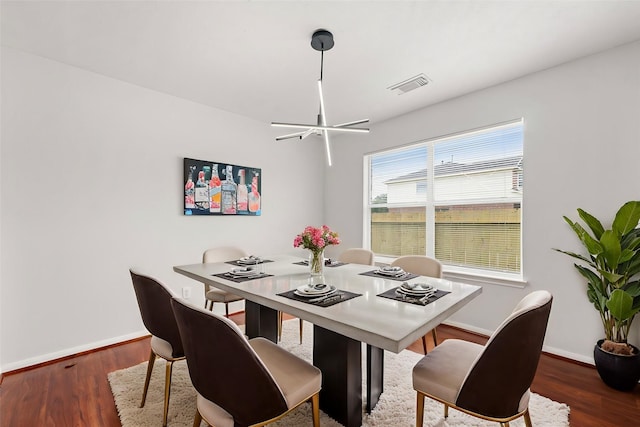 dining room featuring a chandelier and dark hardwood / wood-style floors