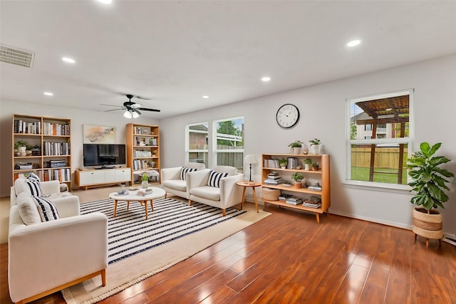 living room featuring hardwood / wood-style flooring, plenty of natural light, and ceiling fan