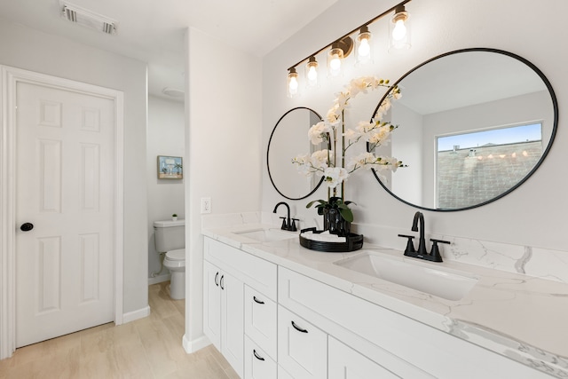 bathroom with vanity and toilet