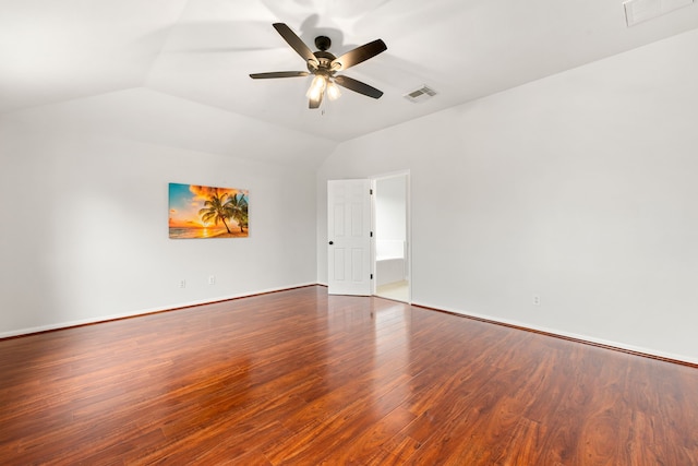 spare room with vaulted ceiling, ceiling fan, and dark wood-type flooring