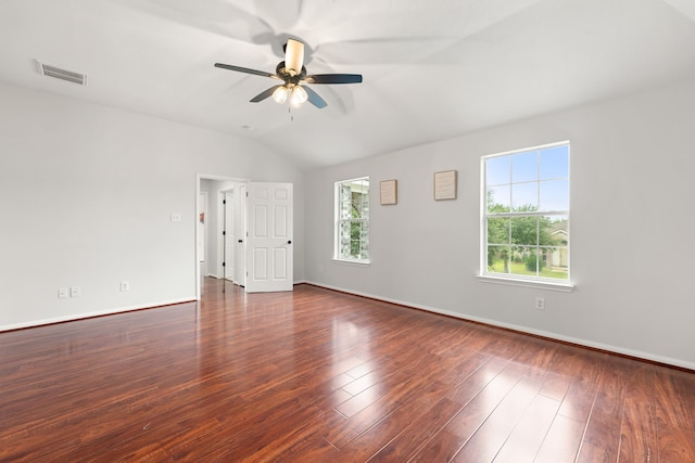 empty room with dark hardwood / wood-style flooring, vaulted ceiling, and ceiling fan