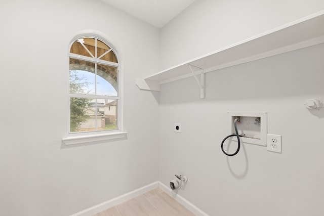 clothes washing area featuring hookup for a gas dryer, light tile patterned floors, washer hookup, and hookup for an electric dryer