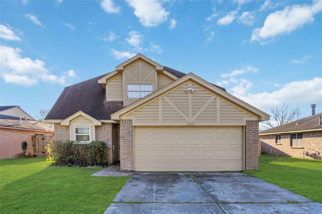 view of front of house with a garage and a front lawn