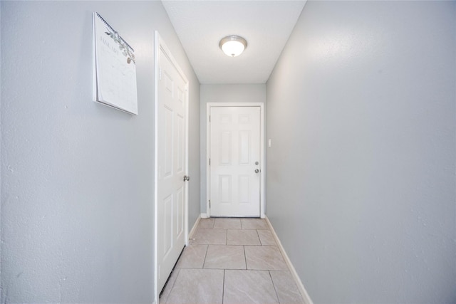 corridor featuring light tile patterned floors