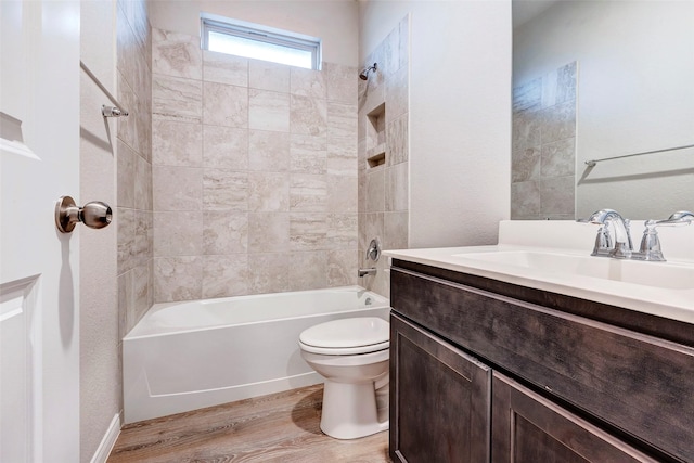 full bathroom with toilet, vanity, tiled shower / bath combo, and hardwood / wood-style flooring