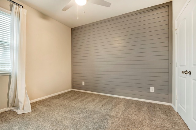 spare room featuring carpet floors and ceiling fan