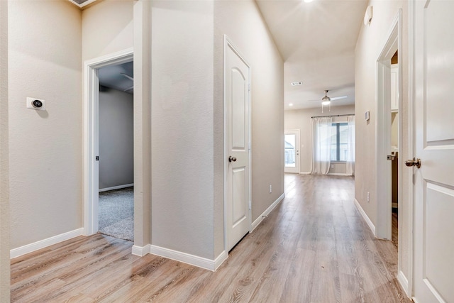 corridor with light wood-type flooring