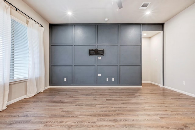 spare room with ceiling fan and light hardwood / wood-style flooring