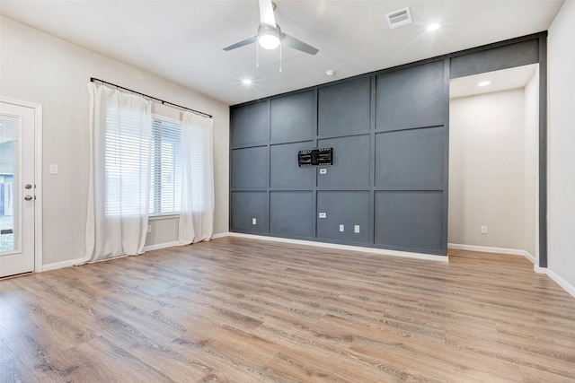 spare room featuring ceiling fan and light hardwood / wood-style flooring