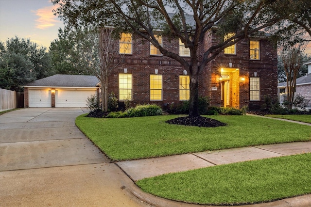 front of property with a lawn and a garage