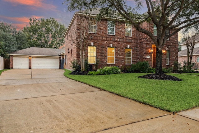 view of front of house with a yard and a garage