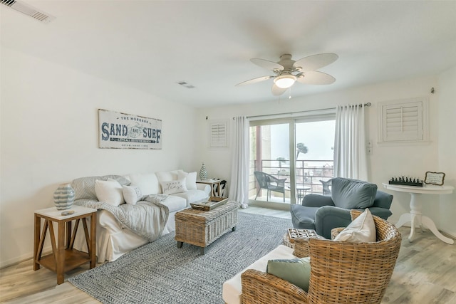 living room with ceiling fan and light hardwood / wood-style floors