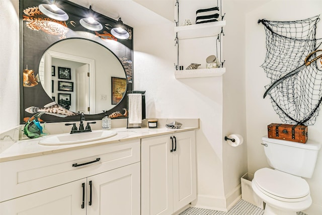 bathroom with toilet, tile patterned flooring, and vanity