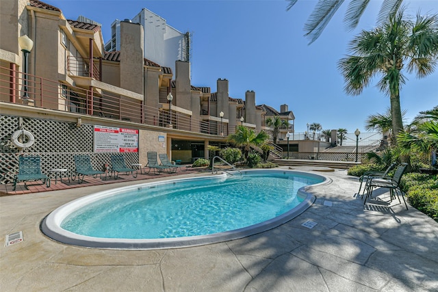 view of swimming pool featuring a patio area