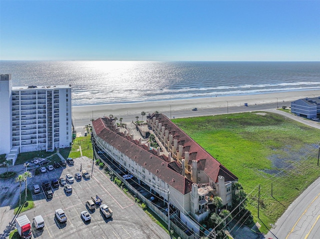 birds eye view of property with a beach view and a water view