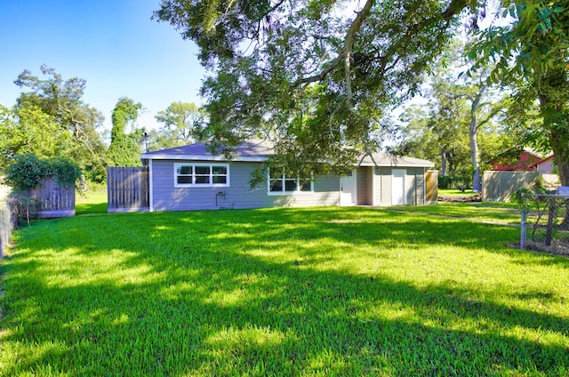 back of property featuring a yard