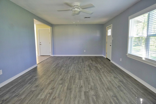 unfurnished room with ceiling fan and dark hardwood / wood-style flooring