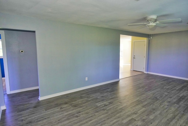 spare room featuring ceiling fan and dark wood-type flooring