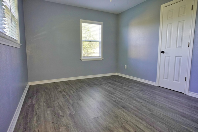 spare room with dark wood-type flooring