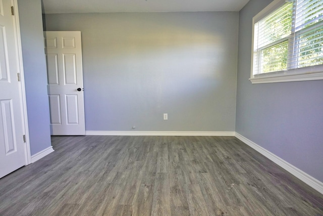 spare room with dark hardwood / wood-style floors