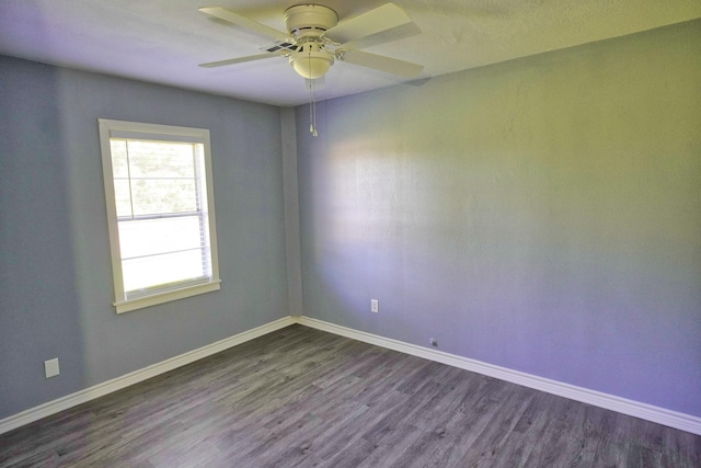 empty room featuring dark hardwood / wood-style flooring and ceiling fan