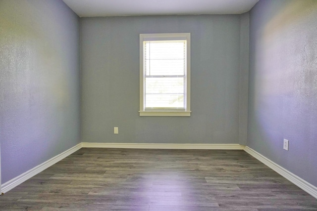 empty room featuring dark hardwood / wood-style flooring