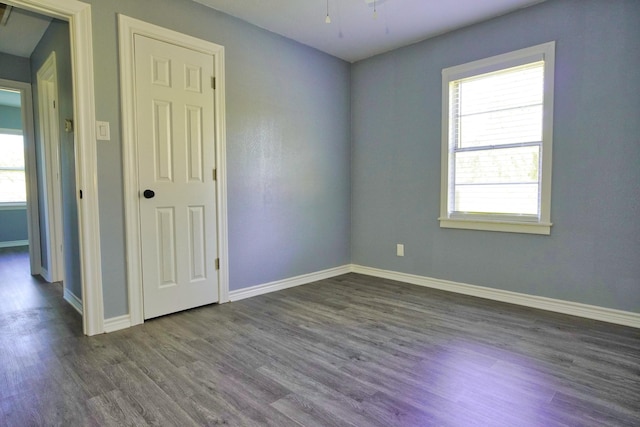 spare room with dark hardwood / wood-style flooring