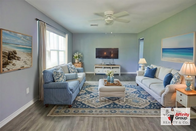 living room with ceiling fan and dark hardwood / wood-style flooring