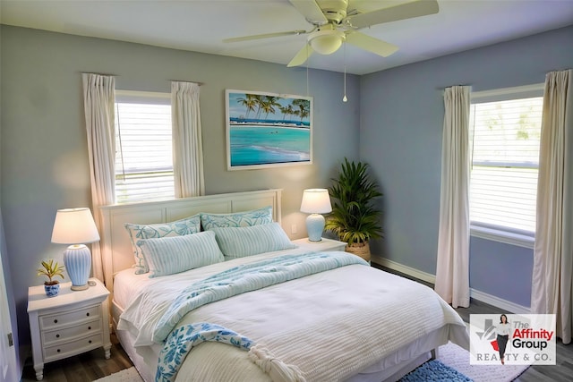 bedroom featuring multiple windows, dark hardwood / wood-style flooring, and ceiling fan