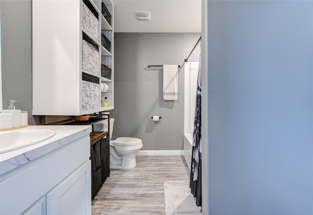 full bathroom featuring shower / tub combination, hardwood / wood-style floors, vanity, and toilet