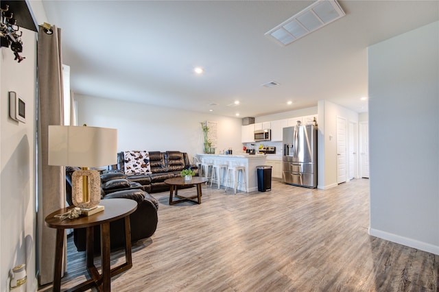 living room with light hardwood / wood-style flooring