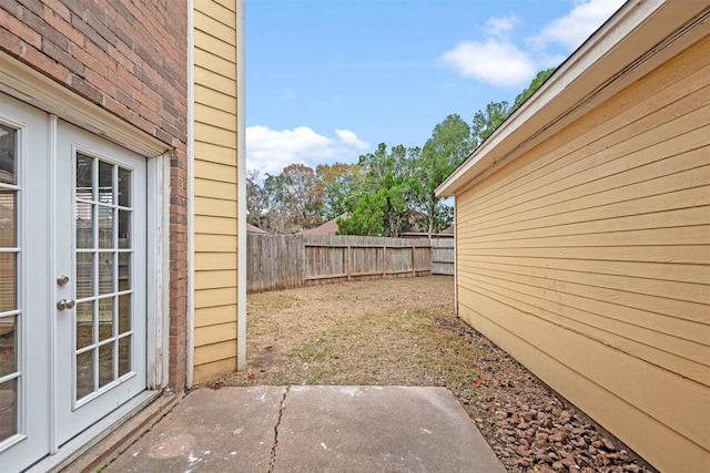 view of yard with a patio and french doors