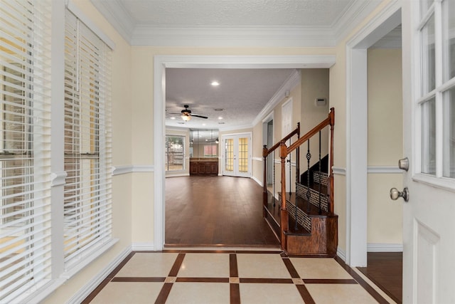 foyer featuring a wealth of natural light, a textured ceiling, and ceiling fan