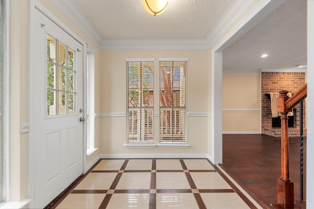 doorway to outside featuring plenty of natural light, ornamental molding, and a textured ceiling