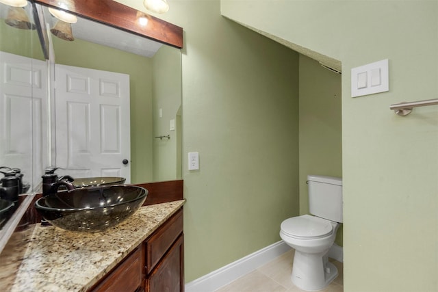 bathroom with tile patterned floors, vanity, and toilet