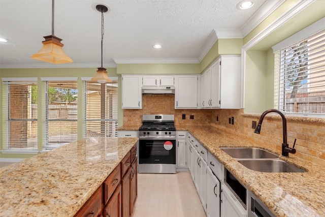 kitchen with pendant lighting, sink, light stone counters, white cabinetry, and stainless steel appliances