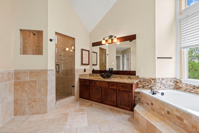 bathroom with vanity, independent shower and bath, and lofted ceiling