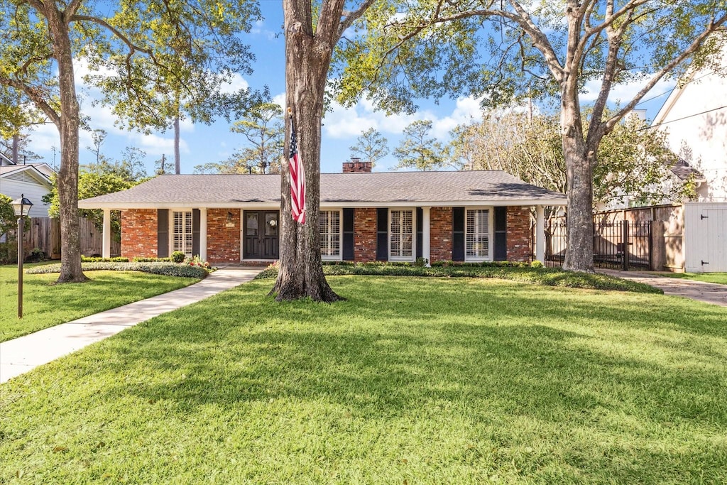 ranch-style house with a front lawn