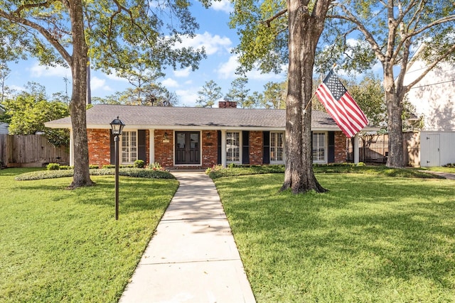 ranch-style home with a front lawn