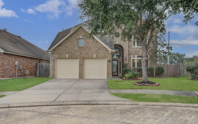 view of front of home featuring a garage and a front lawn