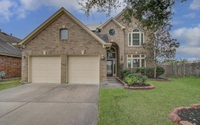 view of front property featuring a front yard and a garage