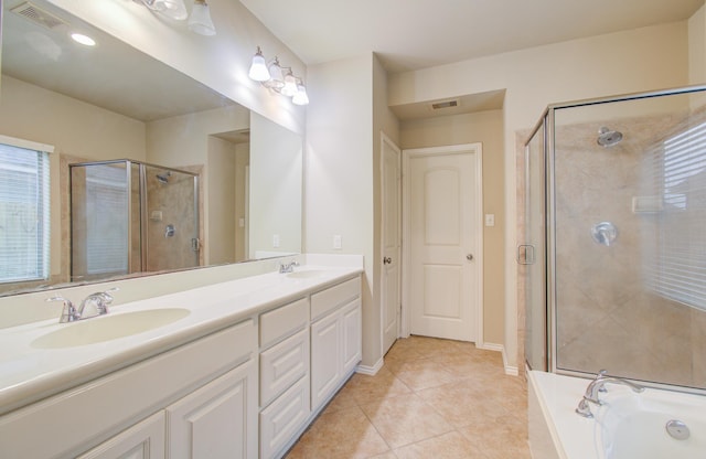 bathroom featuring vanity, tile patterned flooring, and plus walk in shower