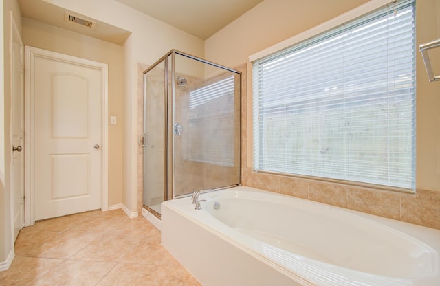 bathroom with tile patterned floors and plus walk in shower